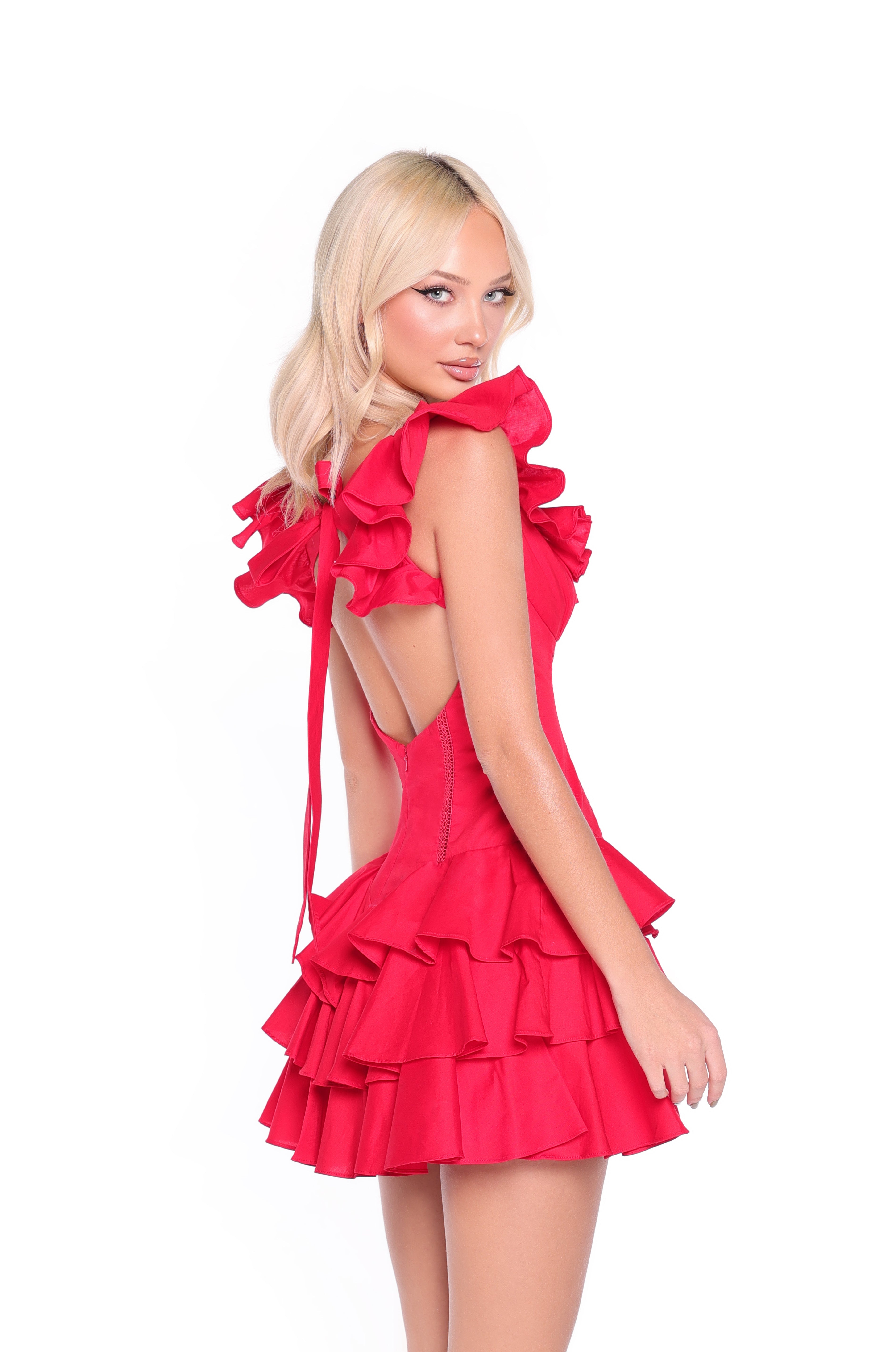 A woman with long blonde hair poses against a white background wearing the Marilyn ruffled short red casual party dress, featuring an open back and perfect for parties.